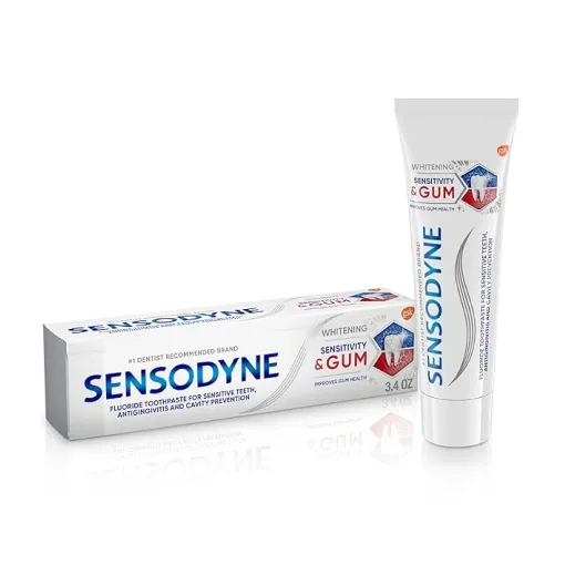 A tube of Sensodyne toothpaste labeled for whitening and sensitivity next to its box.